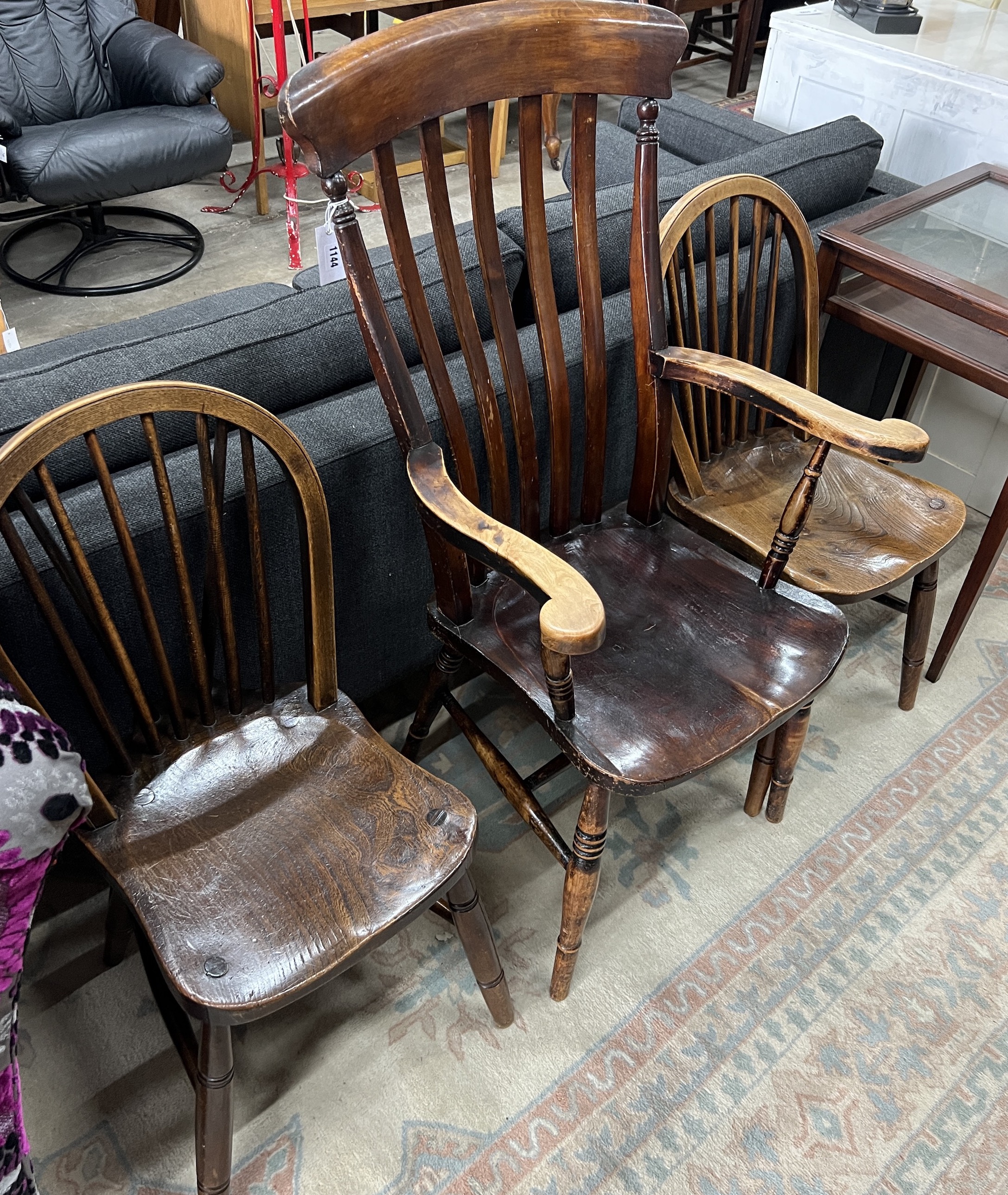 A Victorian elm and beech lathe back Windsor armchair, width 56cm, depth 47cm, height 114cm together with two Victorian Windsor comb back kitchen chairs